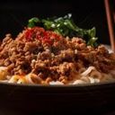 Noodles In A Sptcy Savory Sauce With Minced Pork, Peanuts, And Scallions